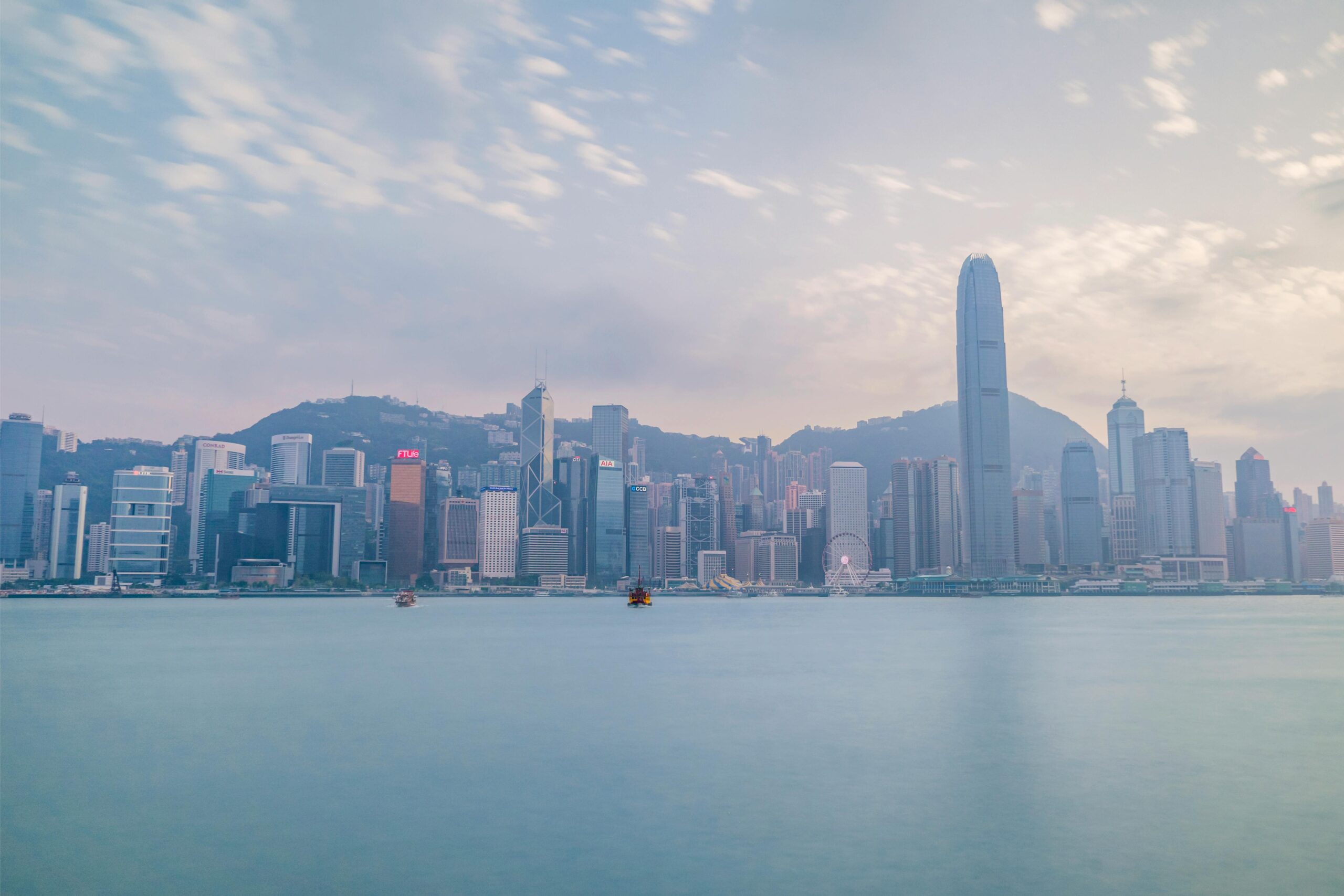 Stunning view of Hong Kong skyline from Victoria Harbour during daylight.